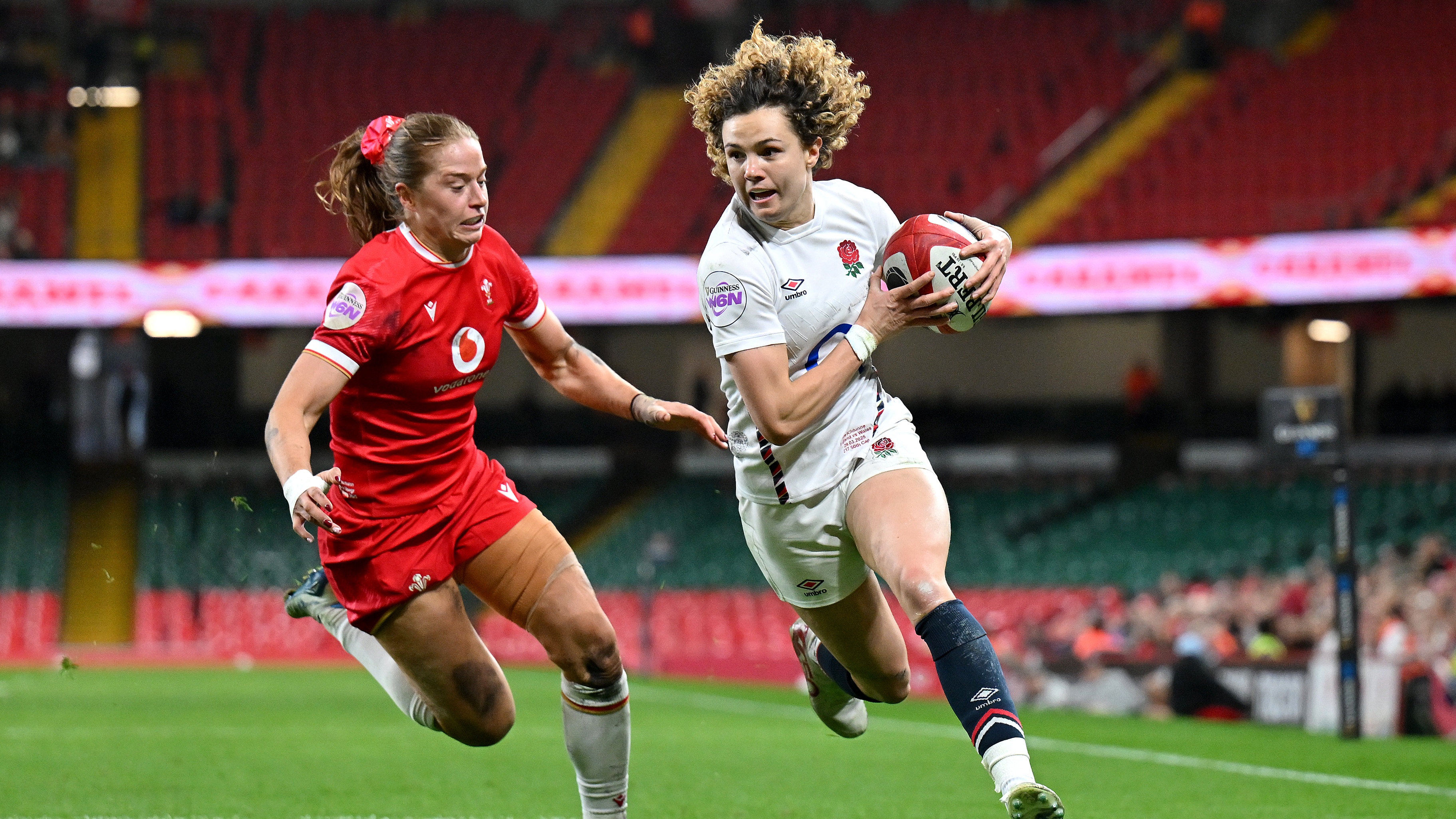 Ellie Kildunne of England breaks past Lisa Neumann of Wales as she runs in to score her team&#039;s fifth try during the Guinness Women&#039;s Six Nations 2025 match between Wales and England at Principality Stadium on March 29, 2025 in Cardiff, Wales. 
