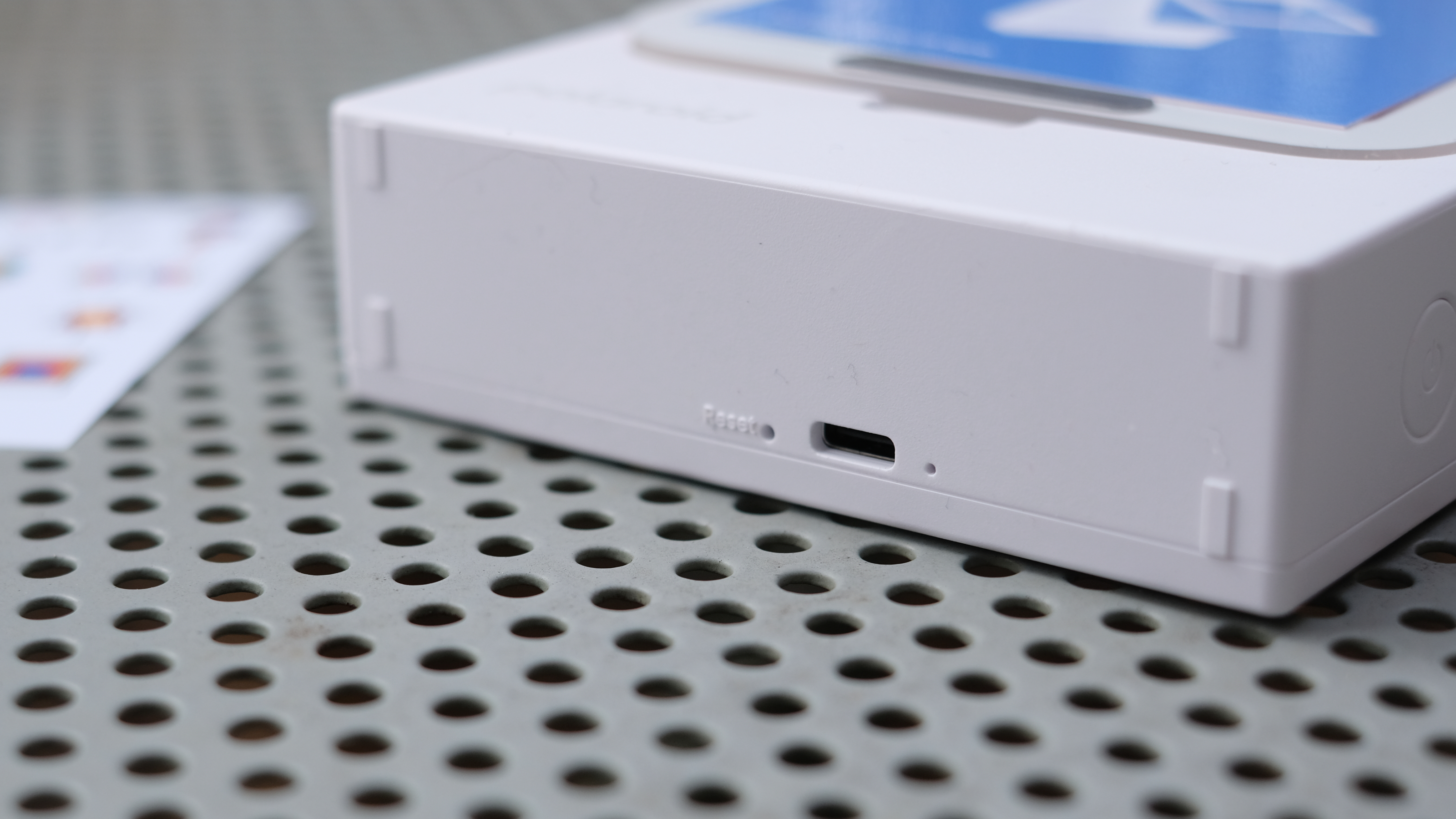 Photograph of Polaroid Hi-Print 3x3 mini instant printer with charging port visible