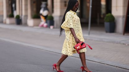 Fashion Week attendee wears yellow dress and red shoes