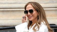 a headshot of jennifer lopez wearing white 