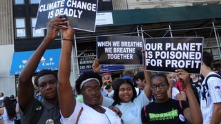 Young activists hold up signs at the Global Climate Strike in NYC on Sept. 20.