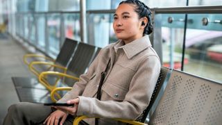 Sony WF-1000XM5 showing person wearing earbuds with an Xperia phone