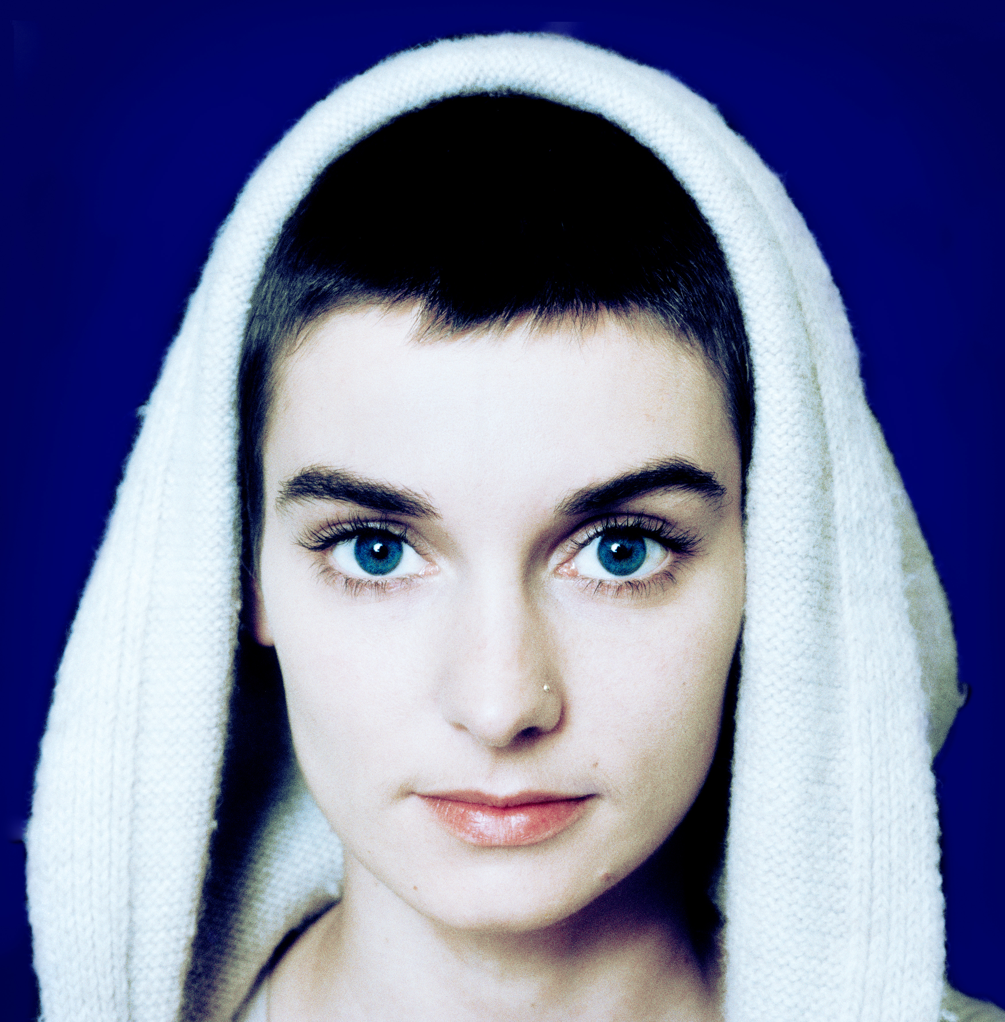 Sinead O'Connor with a with a white robe over her head