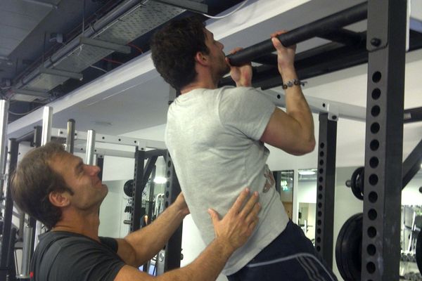 Nick Mitchell helps Joe Warner do a chin-up