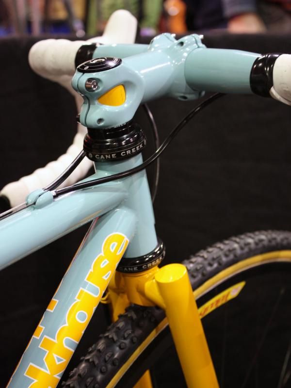 The yellow steerer tube peeks out through the cutout stem clamp.