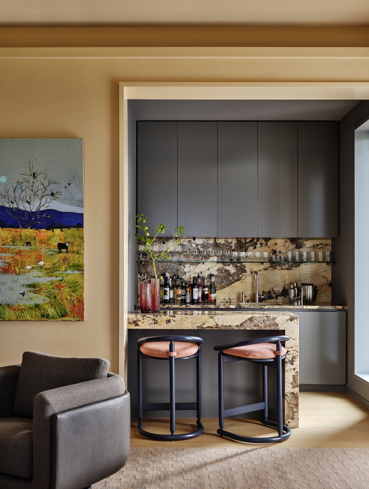 A small kitchen with yellow marble on the counter and backsplash