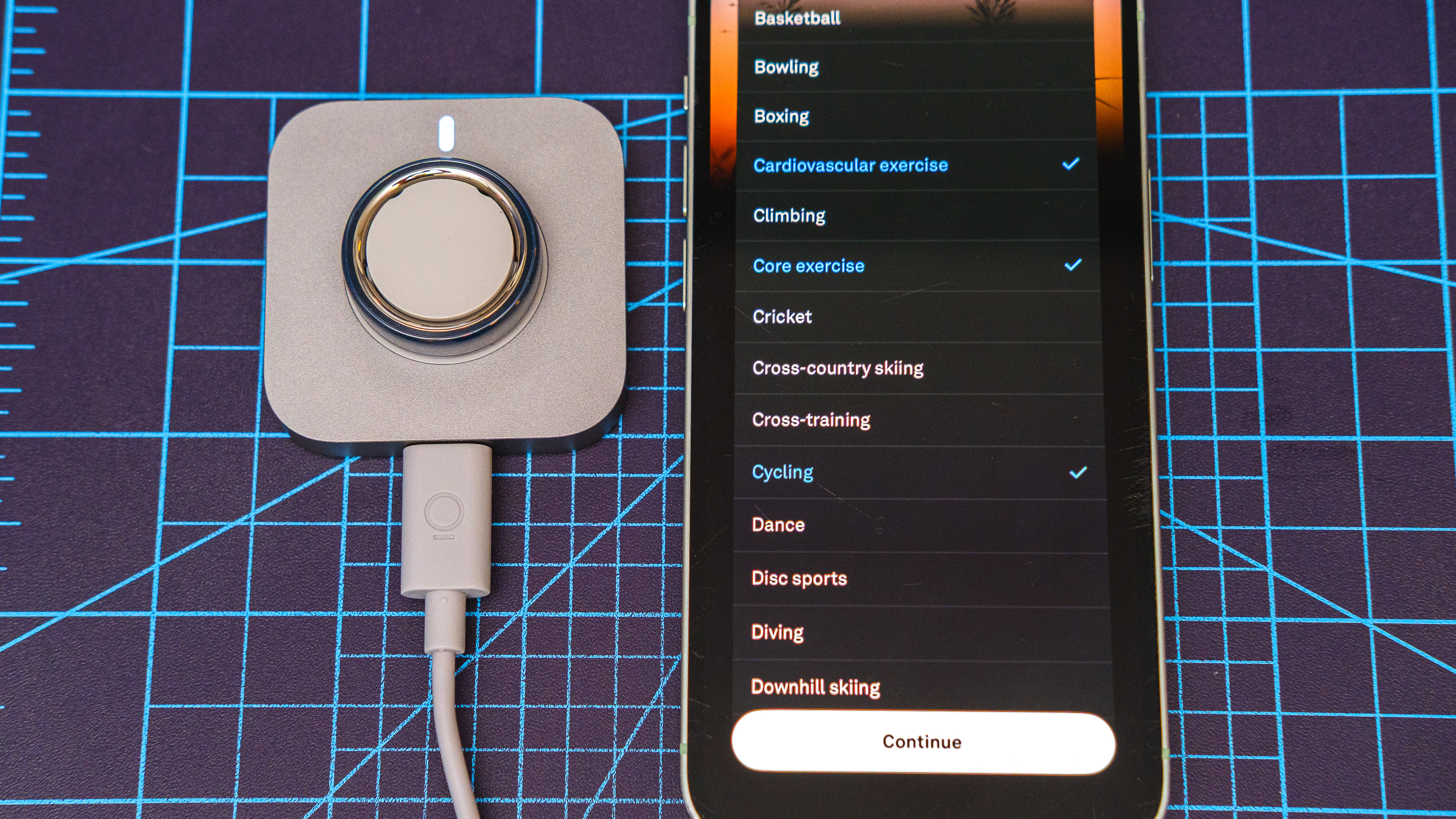 Oura Ring 4 Ceramic close-up showing the setup and pairing process using an iPhone