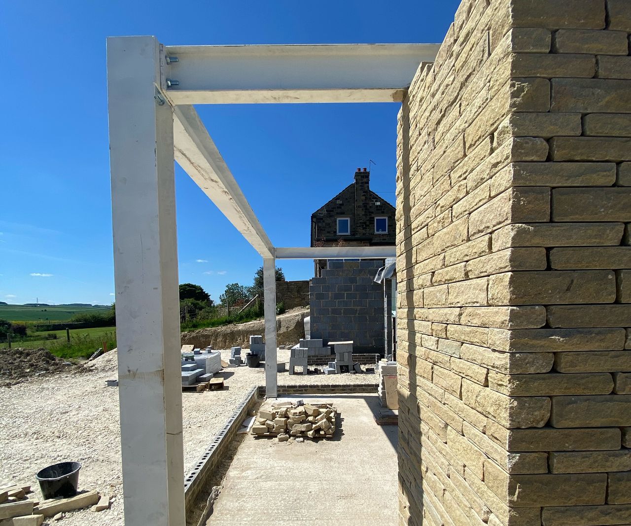 Support beams and brick columns are being constructed for a self build home
