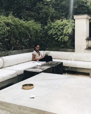 Rick Owens sits on sofa on terrace at home