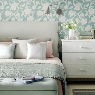 bedroom with floral wallpaper and drawer
