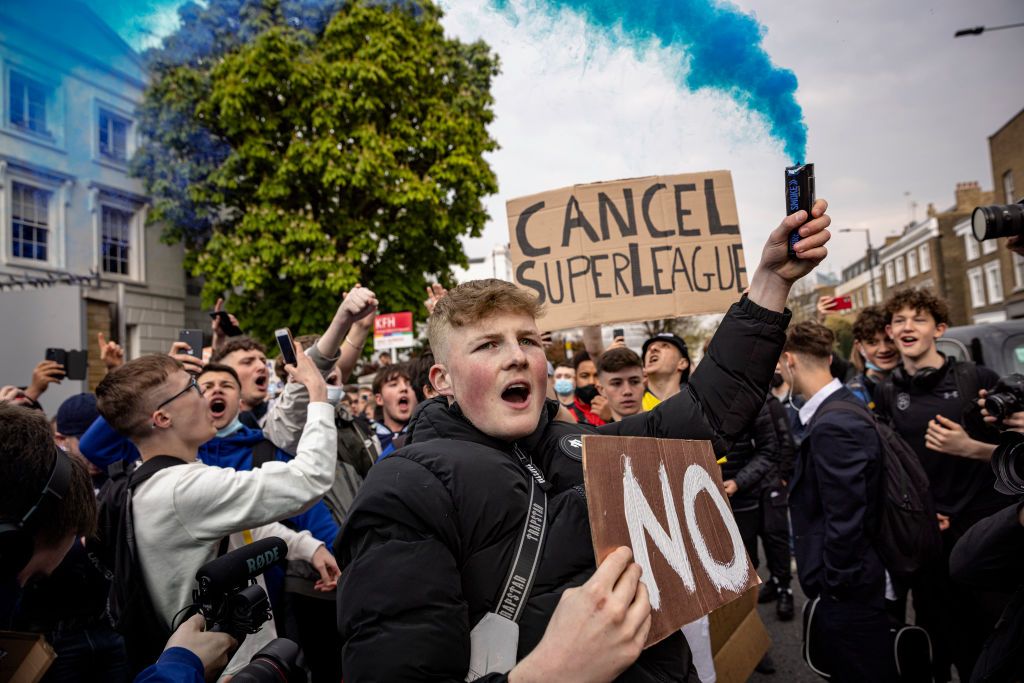 Fans of Chelsea Football Club protest against the European Super League outside Stamford Bridge on April 20, 2021 in London, England. Six English premier league teams have announced they are part of plans for a breakaway European Super League. Arsenal, Manchester United, Manchester City, Liverpool, Chelsea and Tottenham Hotspur will join 12 other European teams in a closed league similar to that of the NFL American Football League. In a statement released last night, the new competition &quot;is intended to commence as soon as practicable&quot; potentially in August.