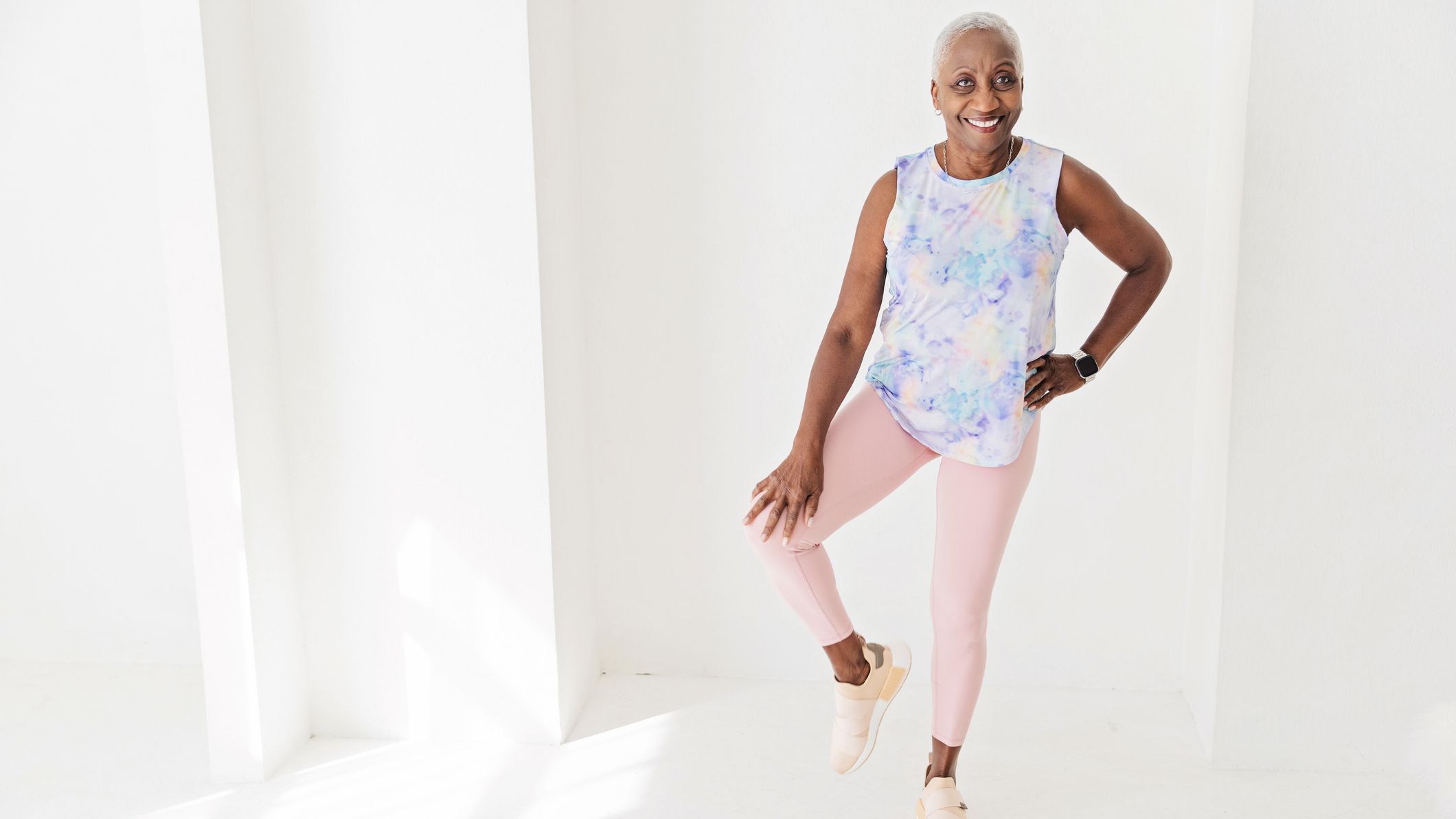 Woman standing on one leg, with her knee out to the side