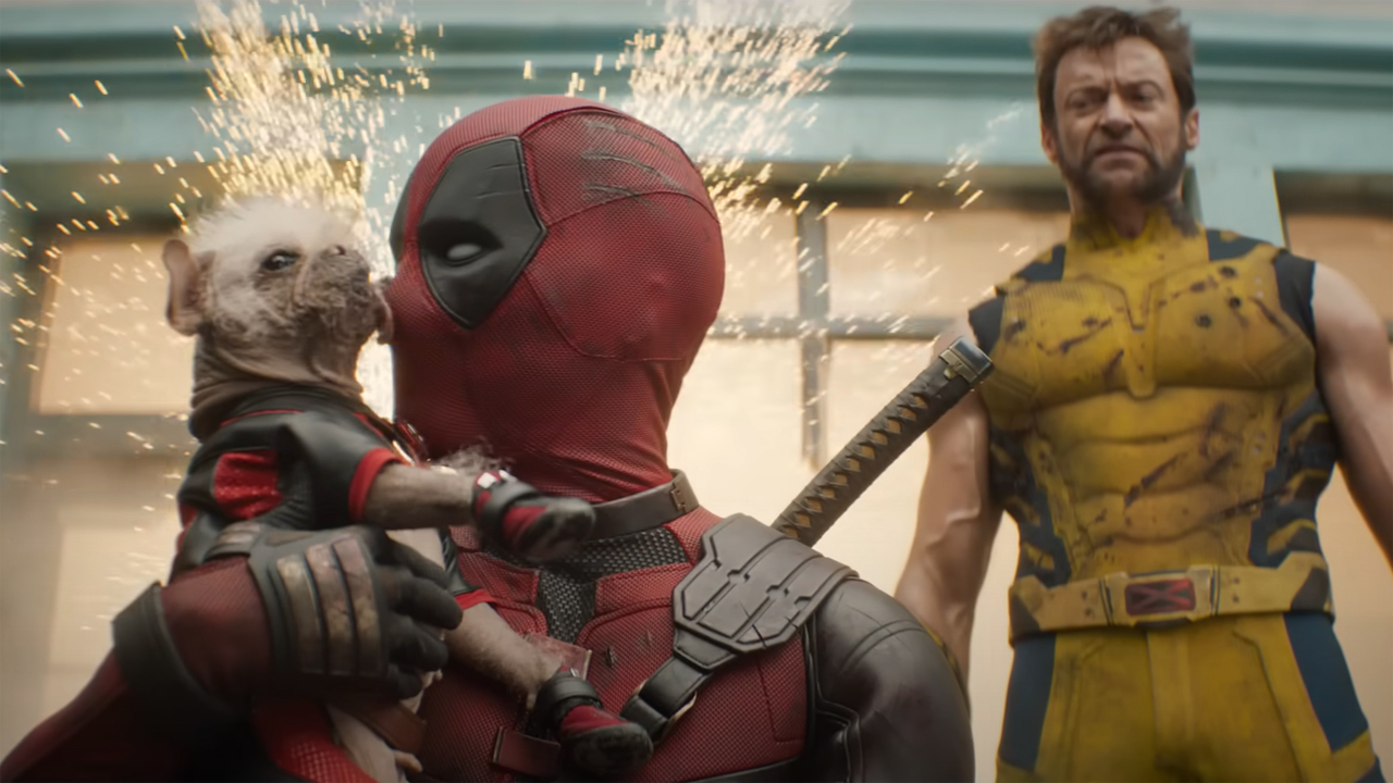 Dogpool licks Deadpool's face as Wolverine looks on in Marvel's Deadpool and Wolverine