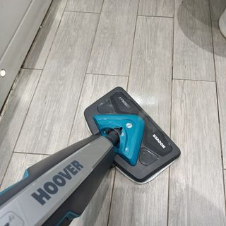 First person view of a Hoover steam cleaner being used to clean a tiled floor
