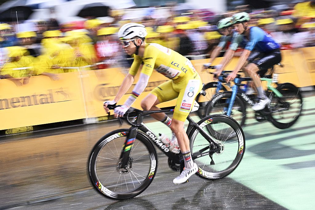 Tadej Pogačar finishes safely in the field on a rain-soaked stage 17 at the Tour de France