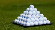 A pyramid of golf balls on the driving range