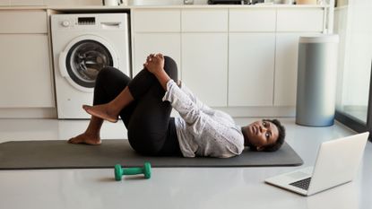 A woman stretching on a yoga mat