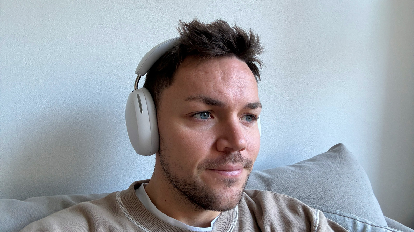 Sonos Ace headphones in soft white being worn on head