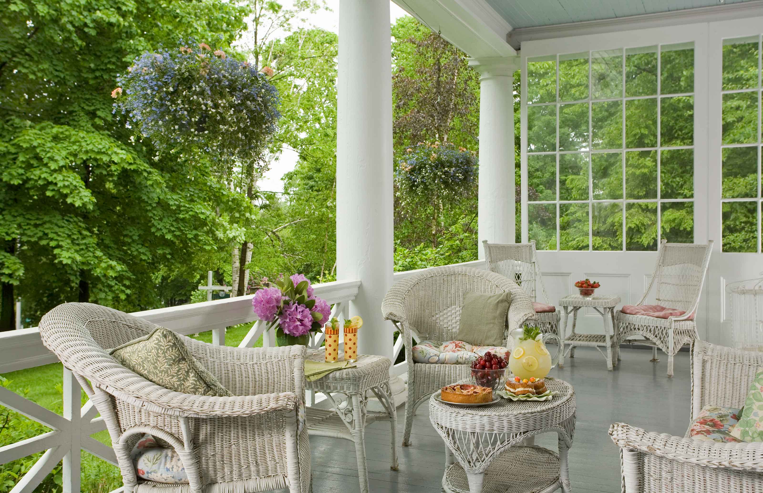 porch with chairs and vases of flowers