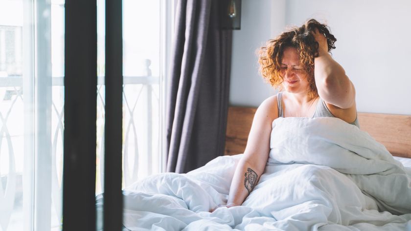 A woman waking up groggy in the morning experiencing sleep inertia