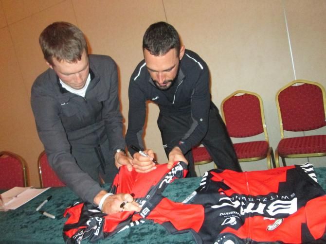 Rohan Dennis and Manuel Quinziatio  two of the BMC Racing Team's riders on its world champion gold medal team time trial squad  signed jerseys after the media training.