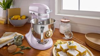 KitchenAid stand mixer in Wildflower on kitchen counter with cakes and baking ingredients