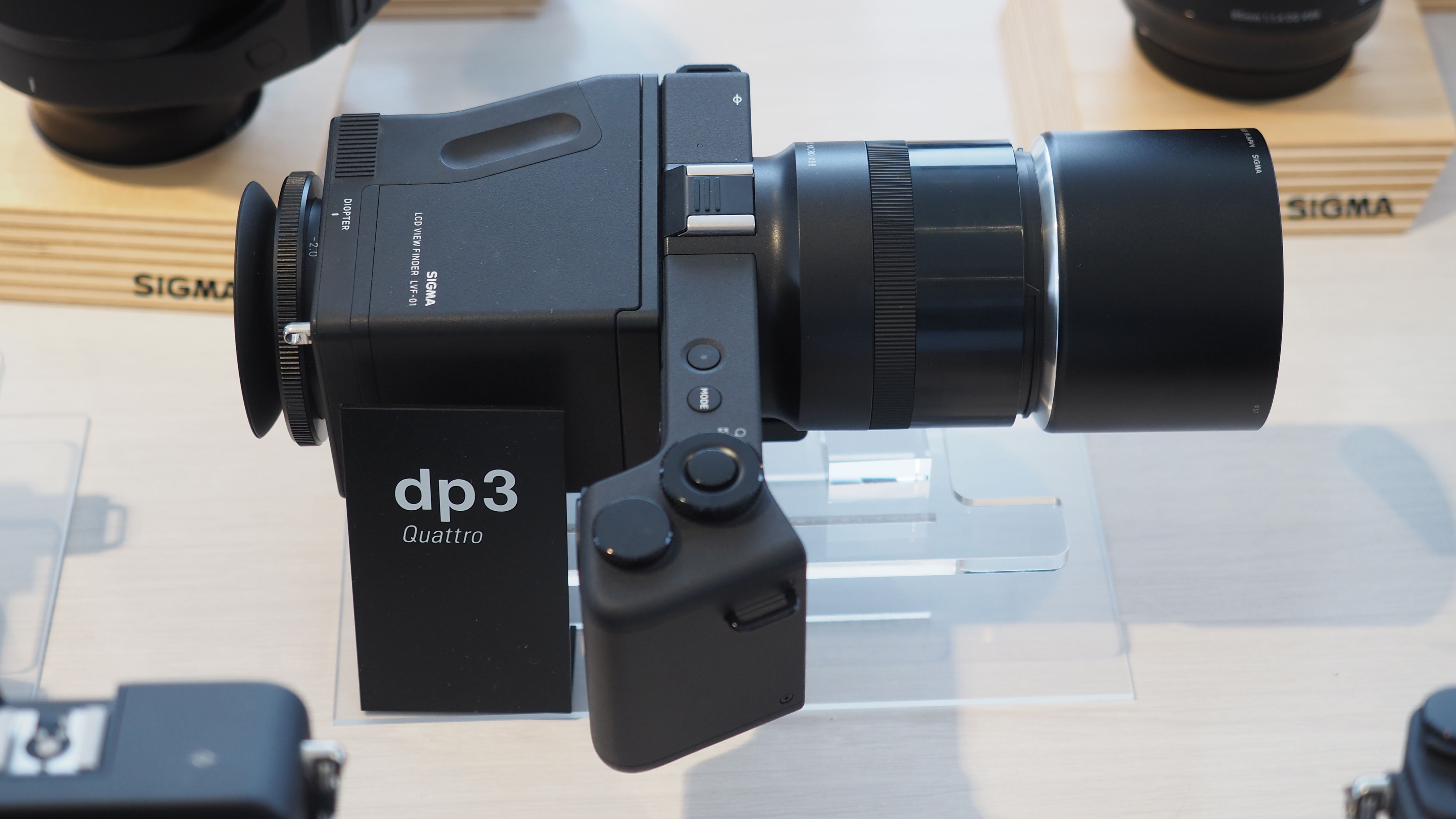 Sigma DP3 Quattro with LVF-01 Finder on a Sigma display stand