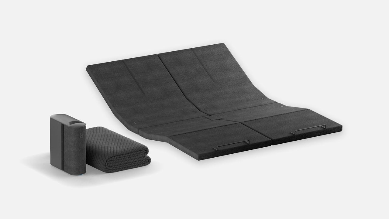 The Eight Sleep Pod 4 Ultra Base, the Pod 4 control hub, and the Pod 4 mattress cover folded, against a white background