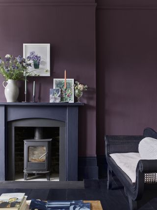 dark purple living room with black fireplace and stove