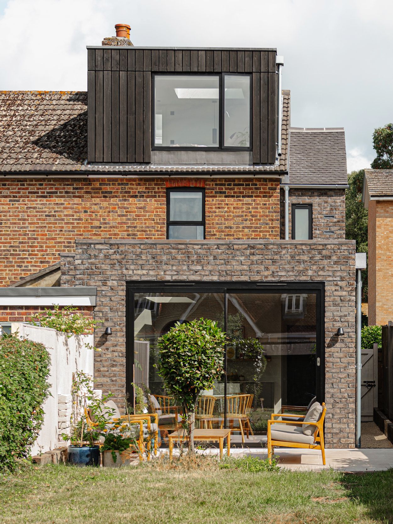 The exterior of a victorian end of terrace property with a modern extension