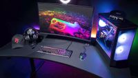 Arozzi’s Arena Ultrawide gaming desk with monitors, keyboard, and mouse on top
