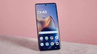 Motorola Edge 60 Fusion against a pink background with display on