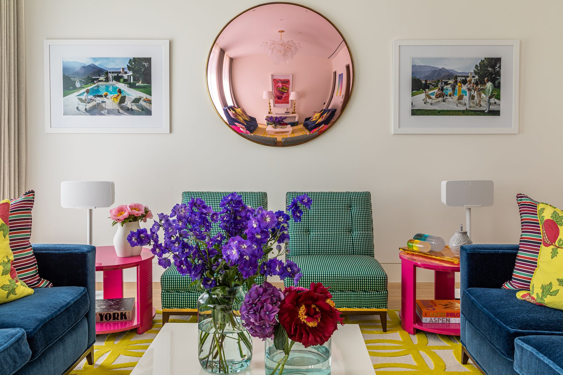 living room with armchairs, rug and mirror