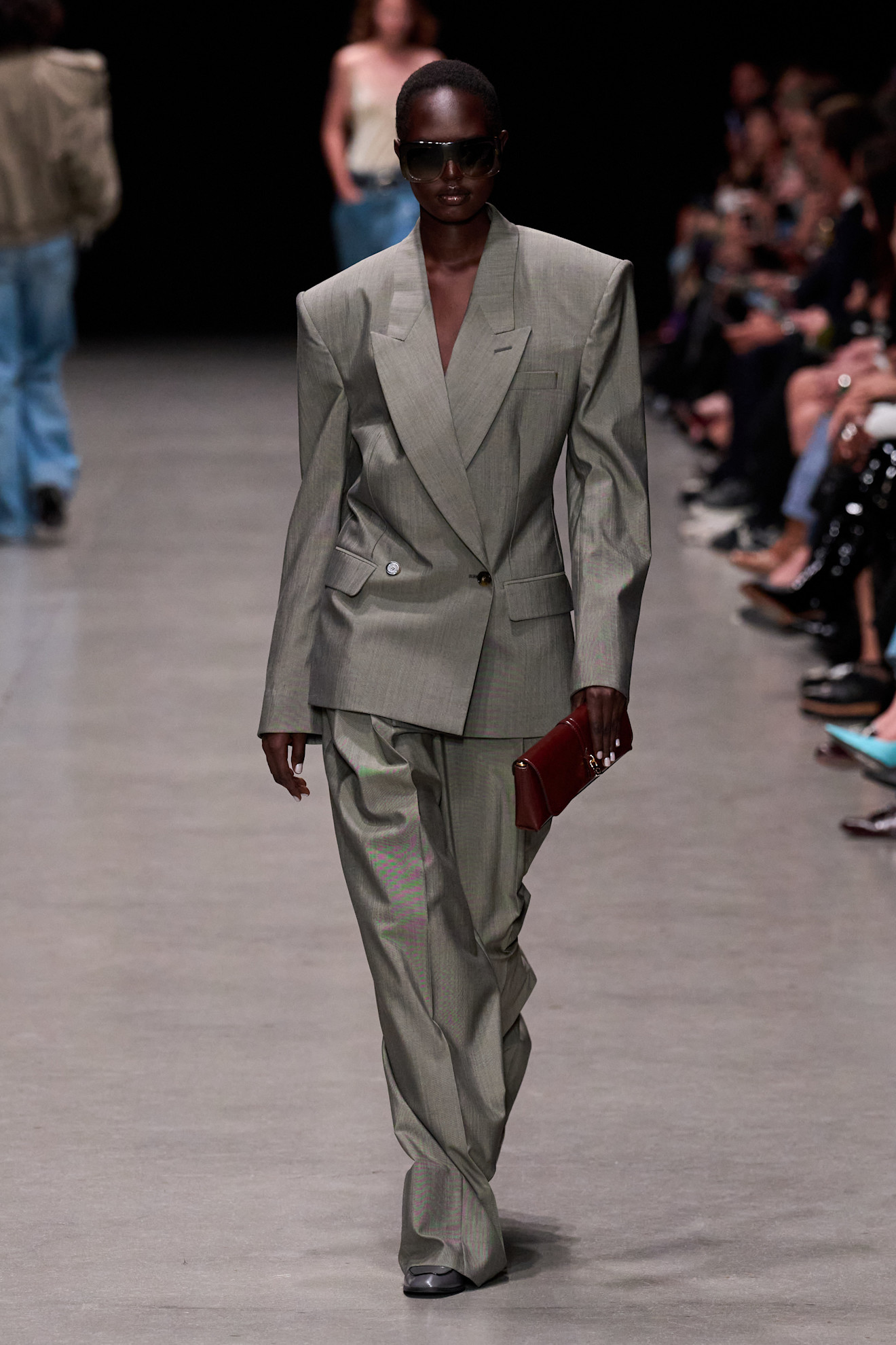 a model at Stella McCartney Spring 2026 wearing a boxy gray blazer and trousers