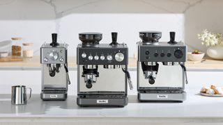 Three Breville coffee machines lined up on kitchen counter
