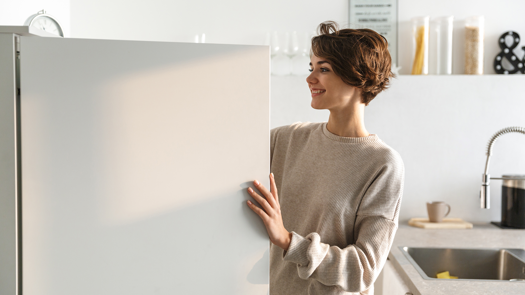 woman standing at the opened freezer