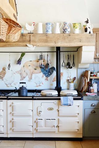 cream aga in a cottage kitchen with mural outside