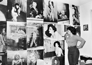woman standing in front of pictures of women