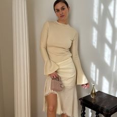 Woman in pale yellow top and skirt