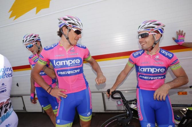 Lampre-Merida teammates Filippo Pozzato and Elia Favilli chat before the start of stage 3.