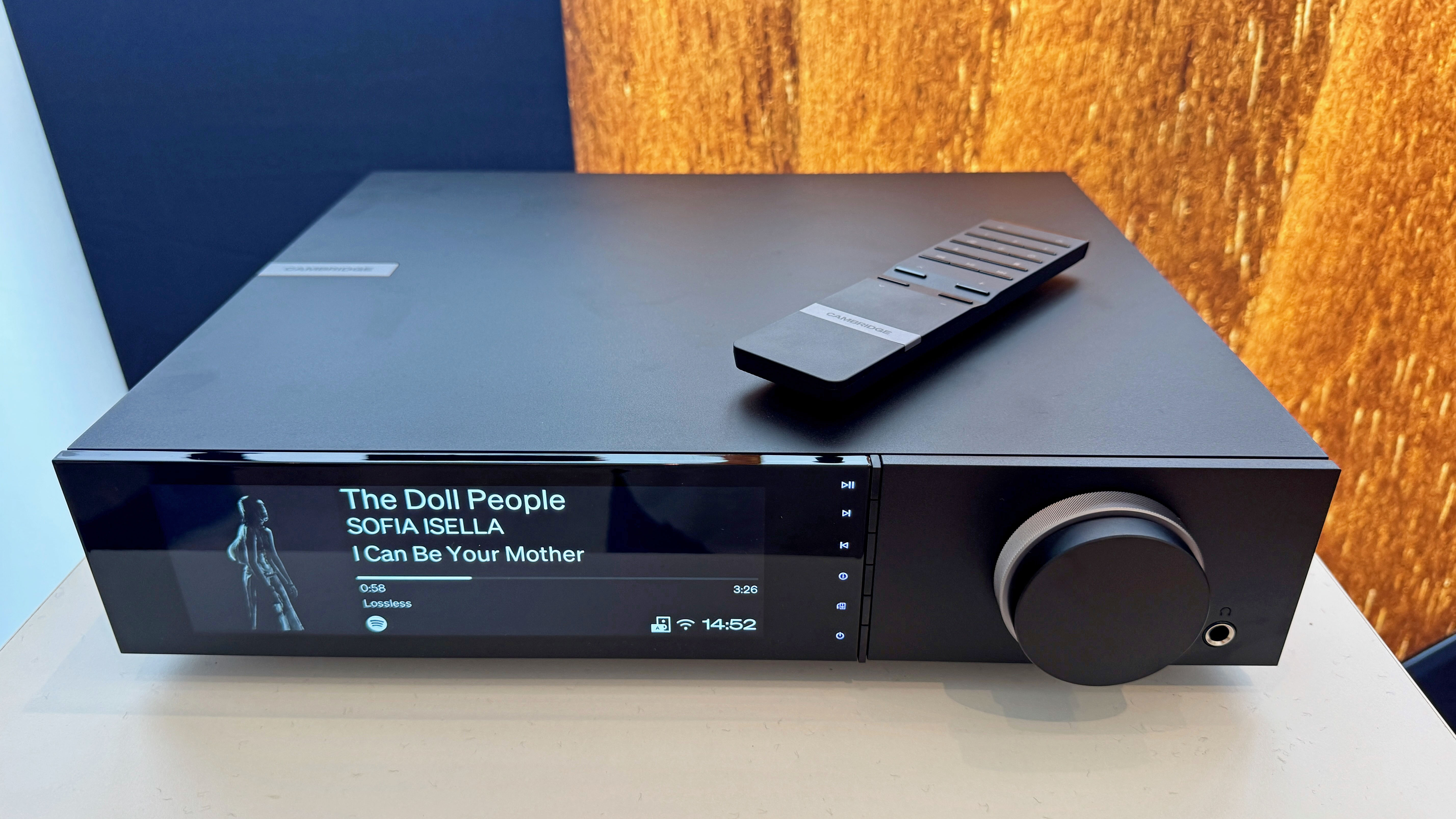 The Cambridge Evo 300 streamer at a trade show showing its remote design laying on top of the device
