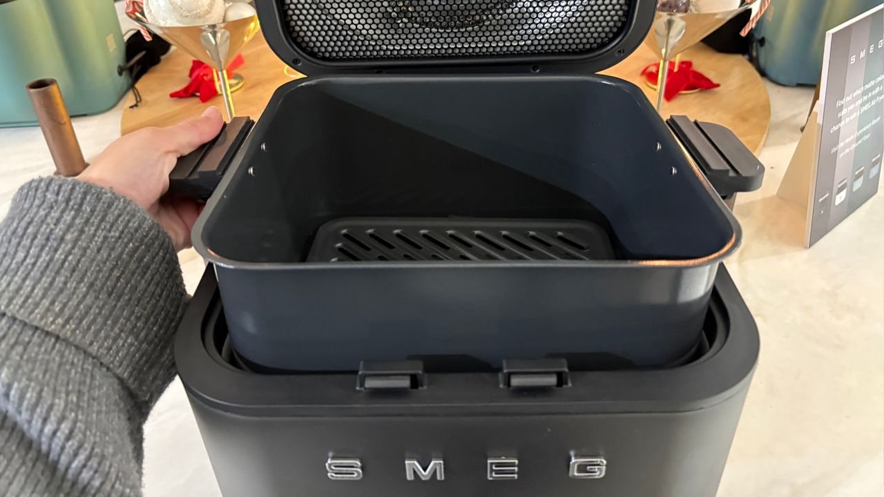 The basket being lifted out of the Smeg Air Fryer