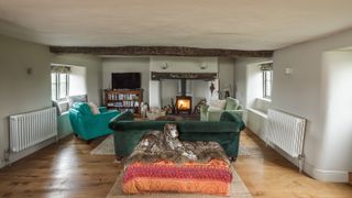 living room in renovation with wooden floors and inglenook