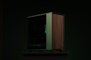 A PC gaming rig designed by Aston Martin, green with wood pannelling