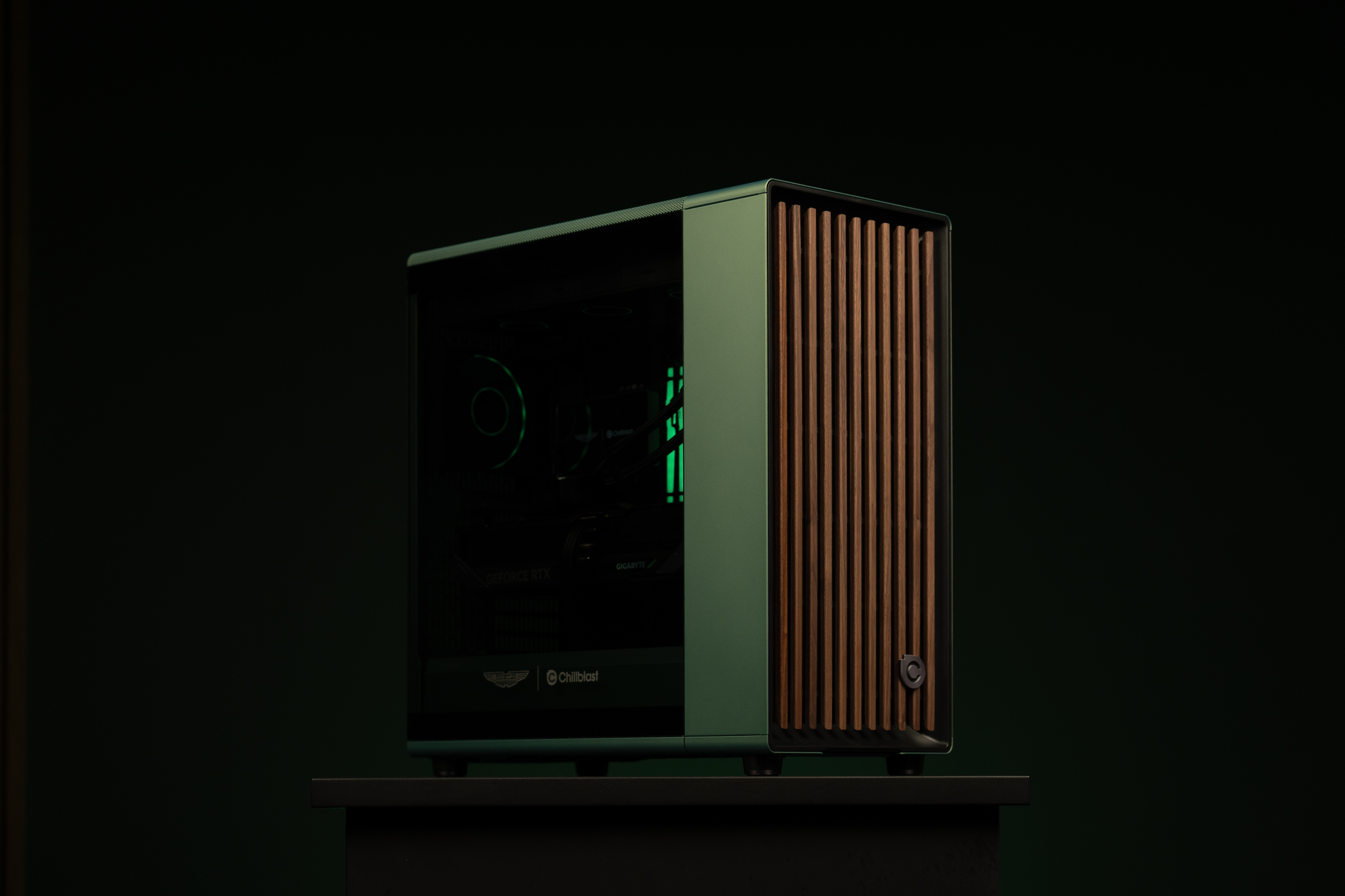 A PC gaming rig designed by Aston Martin, green with wood pannelling
