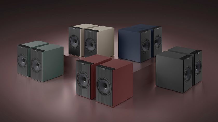 Five pairs of the KEF Coda W speaker arranged on a burgundy red background.
