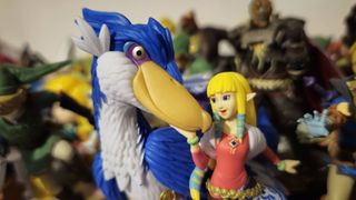 Photo of the Princess Zelda and Loftwing amiibo with a ton of Legend of Zelda amiibo figures blurred behind it.