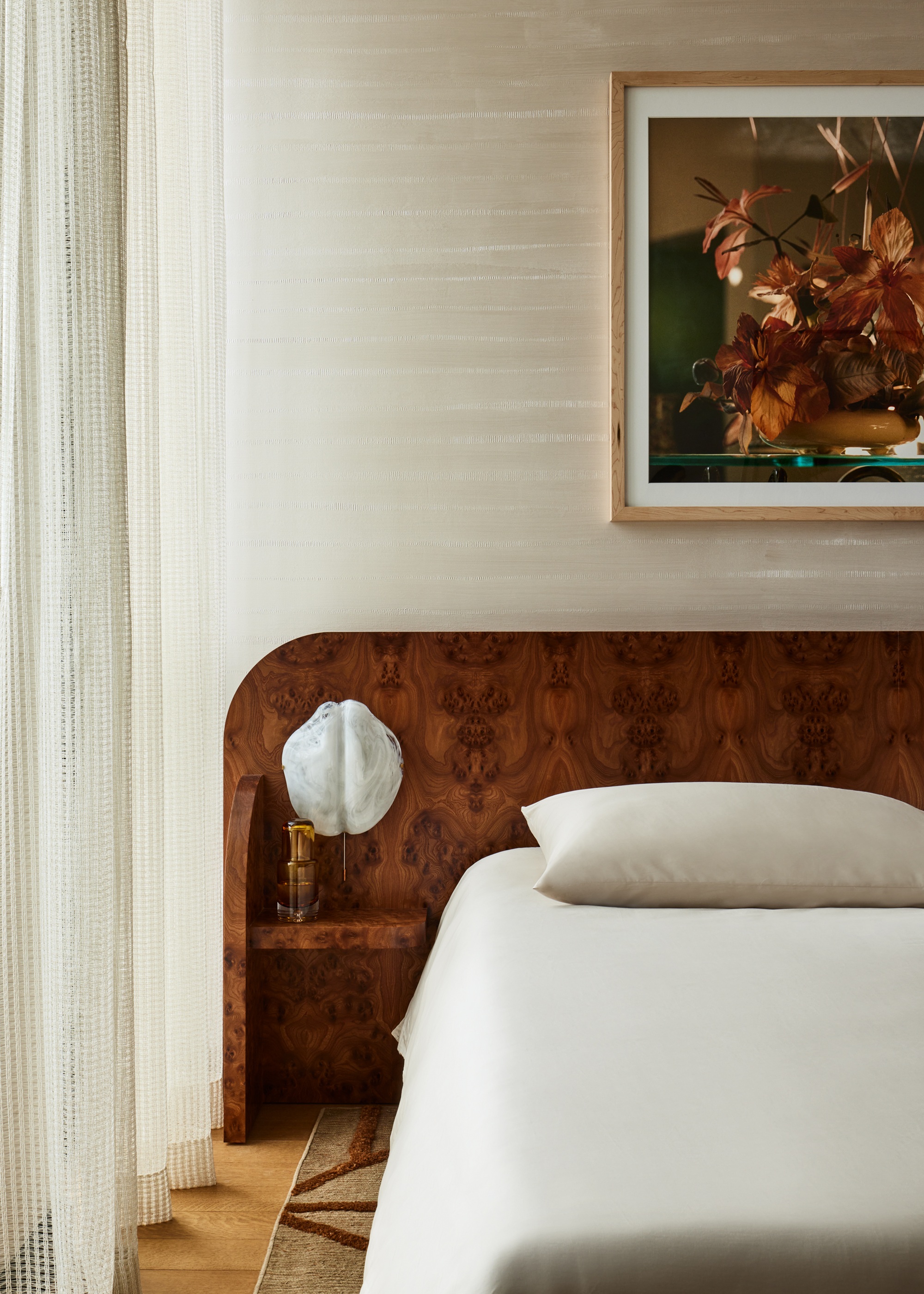 a burled headboard in a bedroom with classic neutral styling