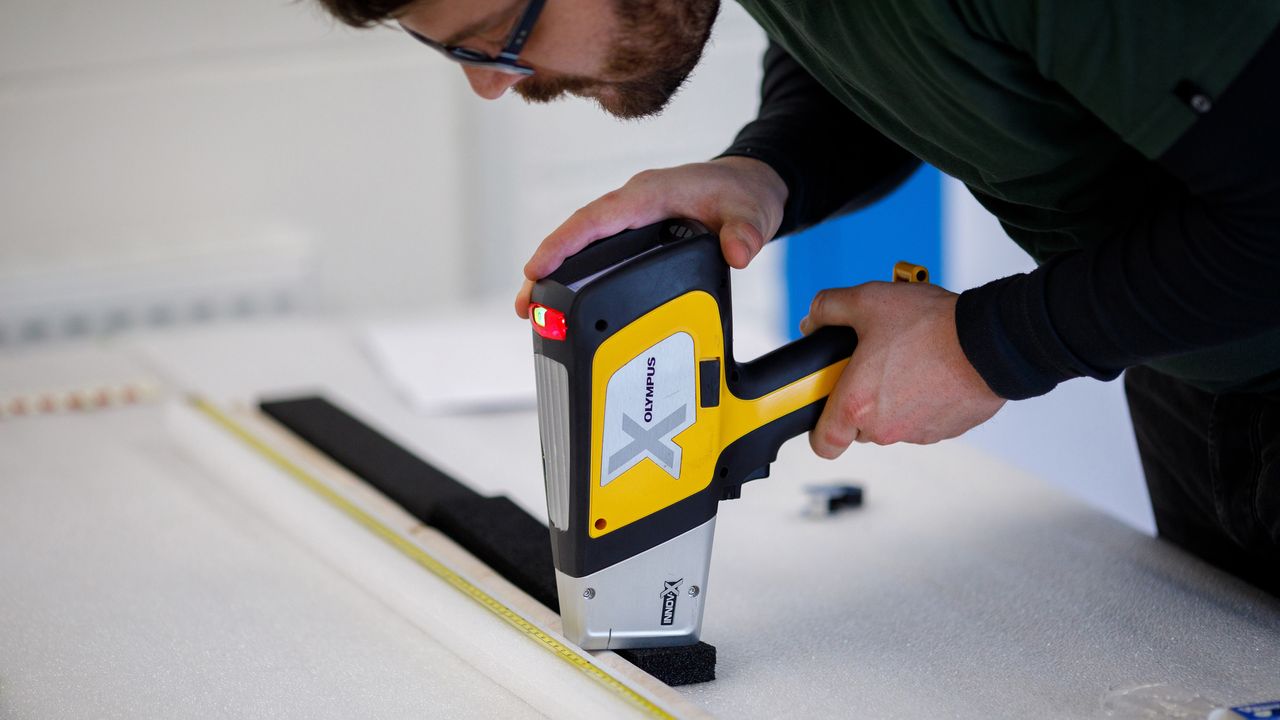 Team member Jake Ciborowski of the University of Brighton examines the stone core from the Stonehenge sarsen using a portable x-ray fluorescence spectrometer.