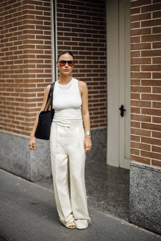 woman wearing white tank top and trousers